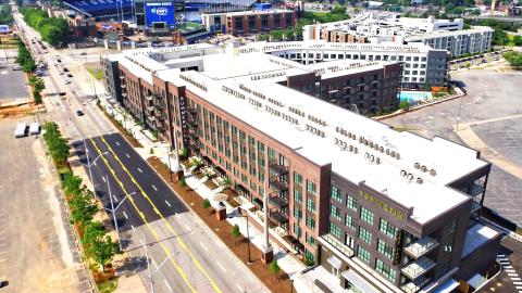 A building building and baseball stadium as seen from the air. 