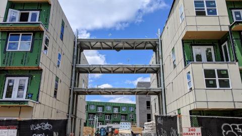 A construction project with two buildings connected by sky bridges. 