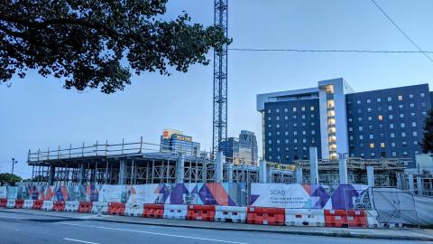 A construction site with buildings coming out of the ground now.