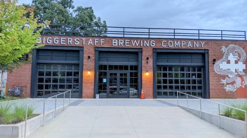 The brick exterior of a small building near the Atlanta BeltLine for a brewery. 