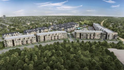 An overview of a huge project of townhomes and apartments in the middle of trees. 