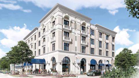 A rendering of a white hotel with blue awnings. 