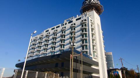 A 1960s white building that's been renovated in Atlanta against blue skies. 