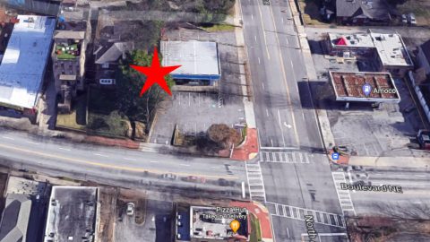 An overview of a corner lot where an old building and a house will be turned into a Starbucks. 