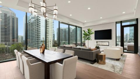 Inside a white condo with wood floors and views of the Atlanta skyline. 