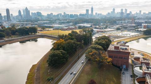 An aerial view over Atlanta with a water reservoir at left. 