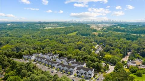 An aerial photo of Atlanta's trees with the city in the distance. 