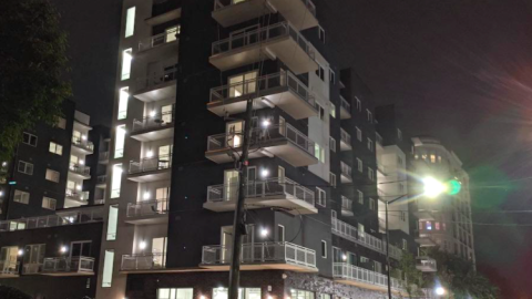 A photo of a hotel with large balconies on a busy street in Atlanta. 