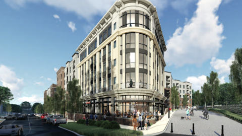 A rendering of a brick condo project along two wide streets under gray skies. 