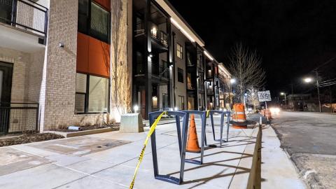 A large apartments complex in photos at night with brick and orange coloring.   