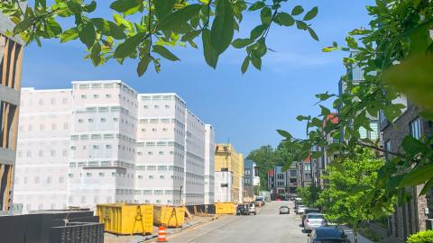An image of a condo community being built among many new trees in Atlanta, under blue skies.