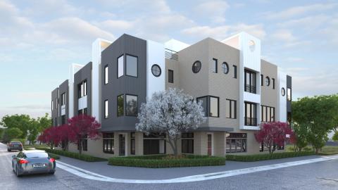 An image showing a modern-style grouping of townhomes on a corner lot under blue skies with clouds.