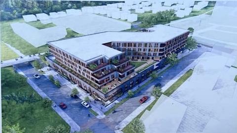 A rendering of a new development with brick and glass beside a large walking path in Atlanta. 