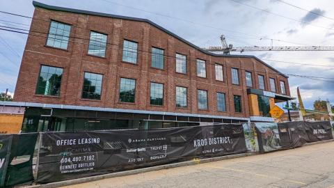 A photo of a new construction project clad in brick under gray skies in Atlanta Georgia.