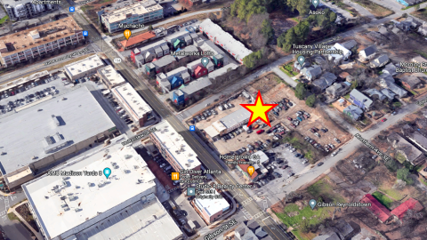 An aerial photo of an auto body yard surrounded by new buildings in Atlanta.  
