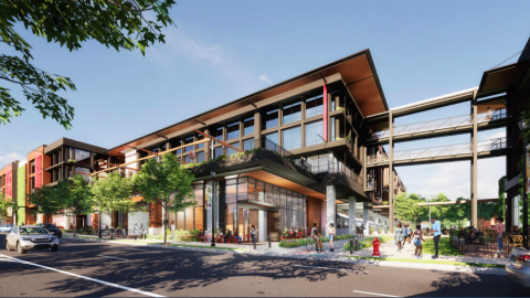 A rendering of a new development with a modern exterior under blue skies. 