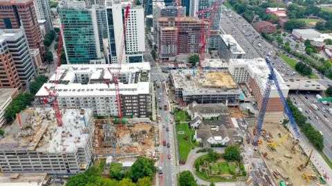 An aerial photo of several large construction site near a huge highway in Atlanta.