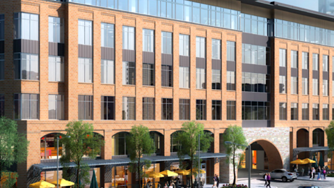 A rendering of a red stone and glass building under blue skies with an oval carport in front.