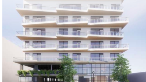 A rendering of a white seven-story building under sunny skies near a busy street in Atlanta, as shown in a rendering.