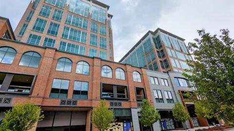 A photo of two glassy and brick buildings under gray skies in Atlanta.
