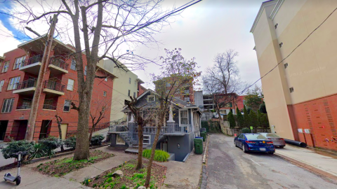 An image of a small home on a tight building site under blue skies in Atlanta. 