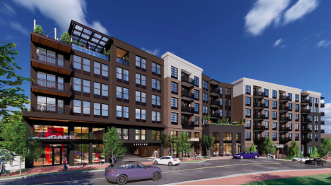 A rendering of an apartment complex under blue skies with cars in front. 