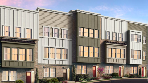 A rendering showing a row of new townhomes under a blue and pink sky near a sloping black street.