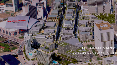 An overview of a large new development with many new buildings beside stadiums and large streets. 