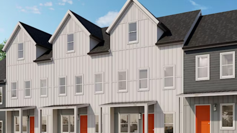 A rendering of a site with gray and white affordable housing built on it under blue skies. 