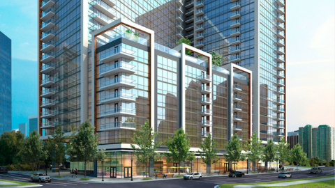 An image showing a large glassy new tower under blue skies in the middle of many buildings in Buckhead Atlanta. 