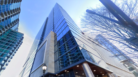 An image of a glassy new apartment tower in Atlanta under blue skies, with small floorplans. 