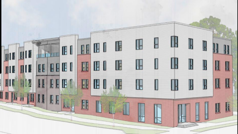 An image of a lot on a corner where a large senior housing complex will be built.