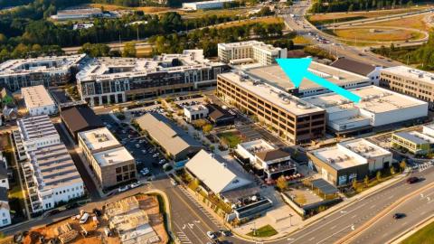 An overview of a large hotel development in a mixed-use district built in many large fields.