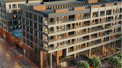 A rendering of a large new apartment complex with a pool near a wide street.