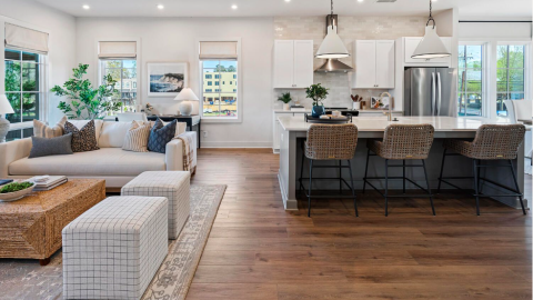 An image of a gray condo building with white interiors that's taken shape near standalone homes in Westside Atlanta.