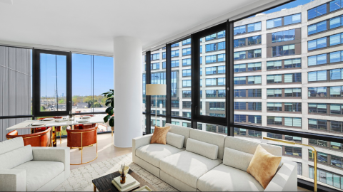An image showing a large white apartment overlooking another building and the Atlanta BeltLine below.