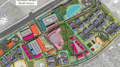 An overview of a development site where a new mini city is planned in the northeast Atlanta suburbs near two major roads. 
