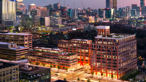 A rendering showing three large new throwback buildings made of brick next to a wide street in the middle of Atlanta.