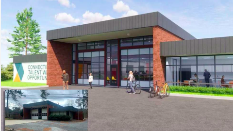 An image showing an old brick boxy fire station with remade interiors under blue skies functioning as coworking space.