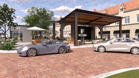 An image showing a new development within an outdoor shopping mall with a park and valet station under blue skies. 