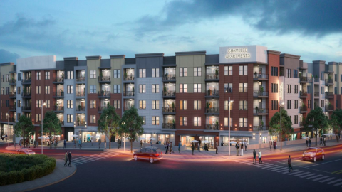 A rendering showing a large development project next to a wide road and many tall trees. 