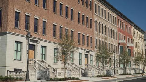 An image show a site with a large tv and film studio and many facades designed to look like cities and huge sound stages indoors.