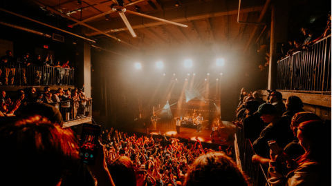 An image of a new concert venue with concrete walls and a large fan overhead in Atlanta. 