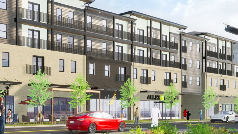 An image showing a large new development in Atlanta under gray skies near a busy street.