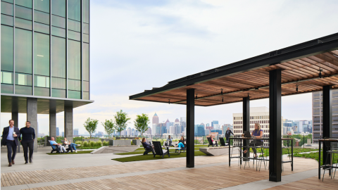 A photo showing a large new office complex in Atlanta made of concrete and glass with views to the city and many buildings. 