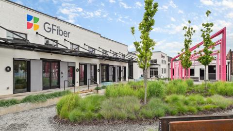 An image of an old warehouse remade with modern interiors and high ceilings with brick walls and new paint on the exterior.