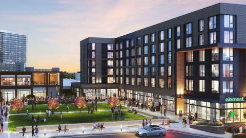 A rendering for new black-painted hotel under pink-gray skies north of Atlanta near many other new buildings. 