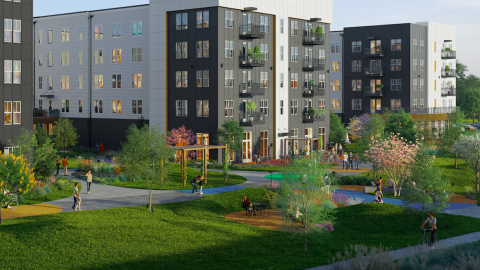 A new large riverside district with several mid-rise buildings and large greenspaces near a river. 